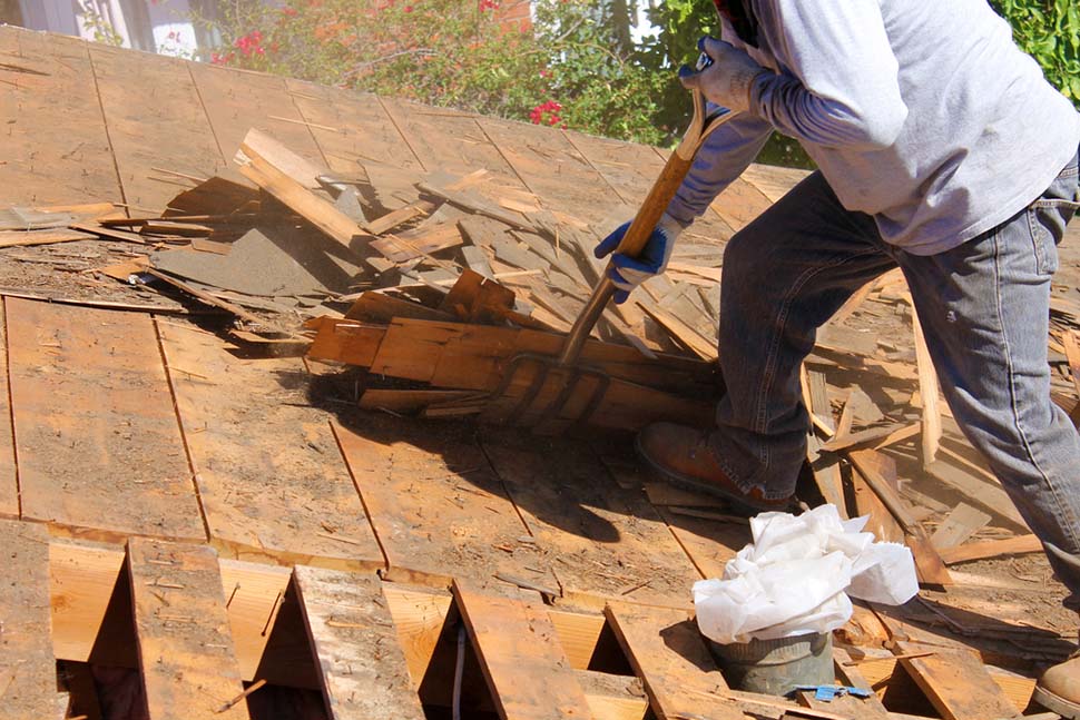 a roofing contractor removing an old roof in order to install a new roof