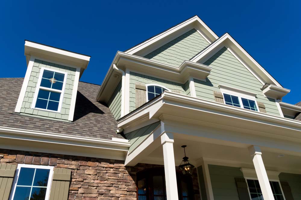 a suburban home with light-colored siding