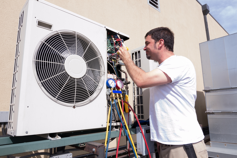 a contractor repairing an air conditioner