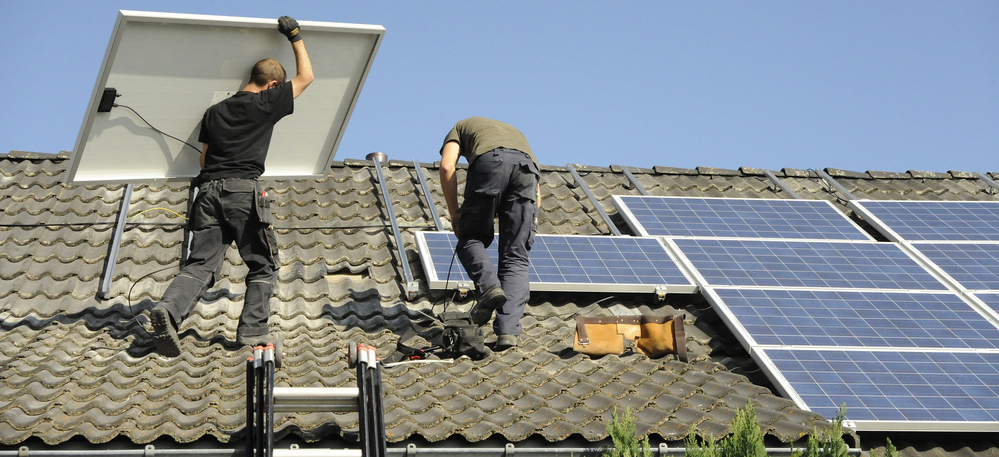 Men at work installing solar panels