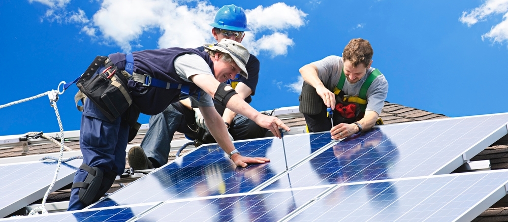 Men working on installing solar panels