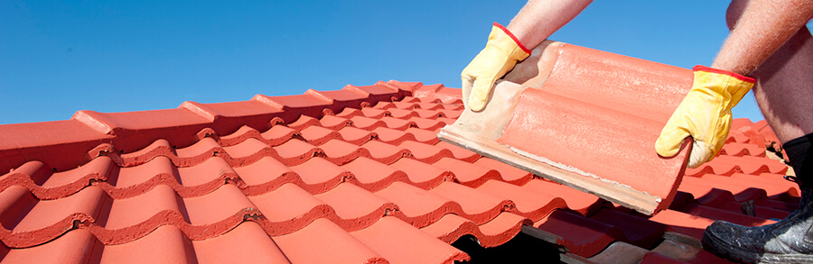 Roofer Repairing Tile Roofing