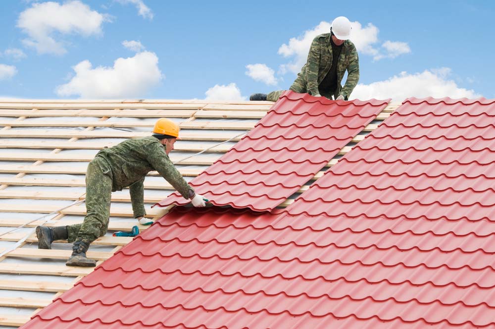 roofing contractors working on a roof to install metal roofing