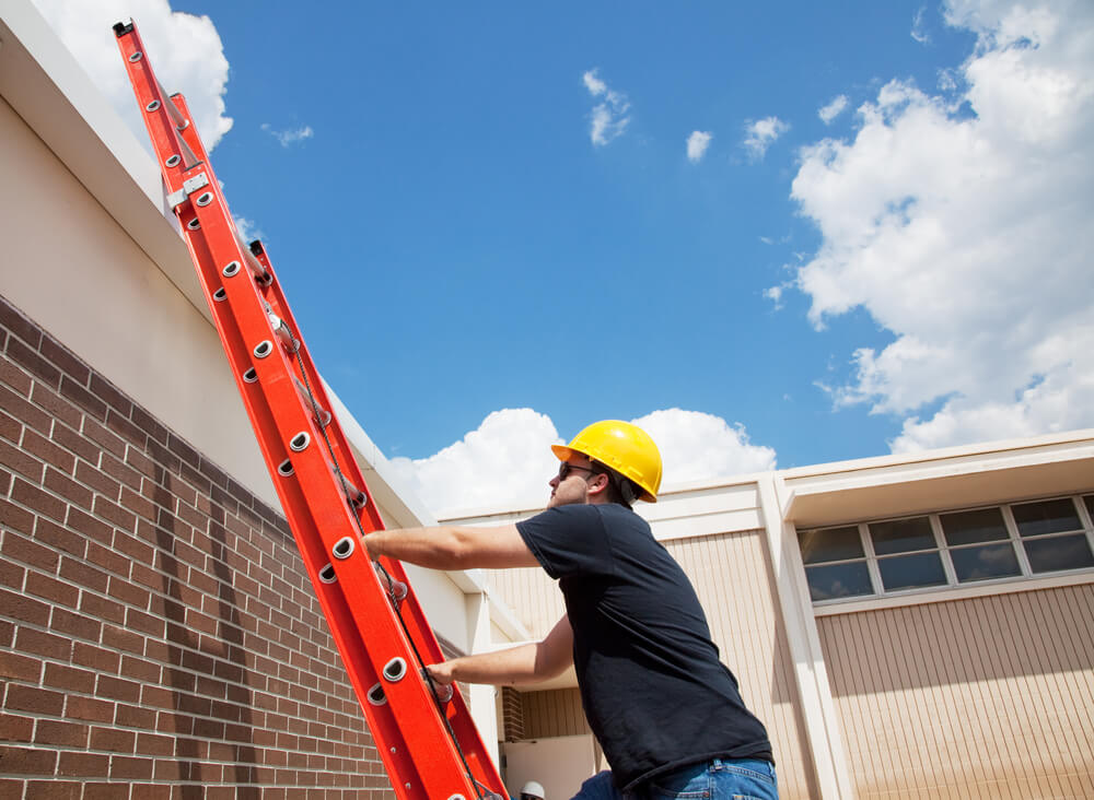 Person working on roof with ladder