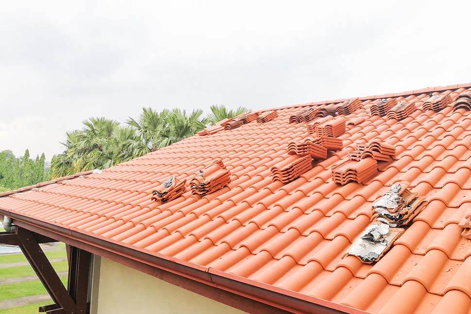 Old tile roofing material being replaced